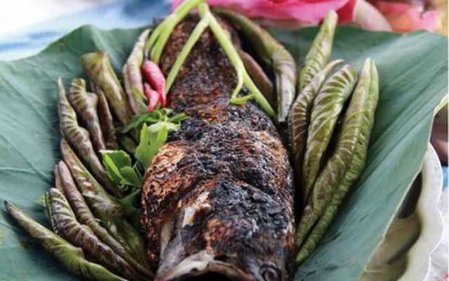 Grilled fish rolled in young lotus leaves